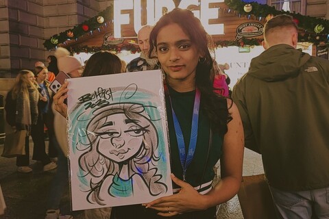 Student with caricature drawing at the Belfast Christmas Market