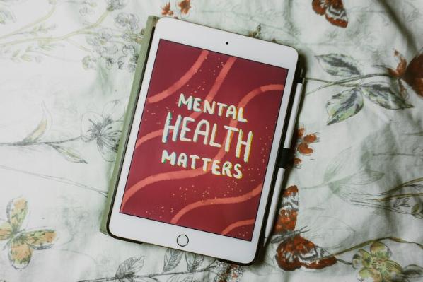 Ipad on bed with Mental Health Matters graphic on the screen