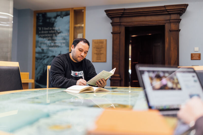 Student Miguel studying in the CS Lewis reading room