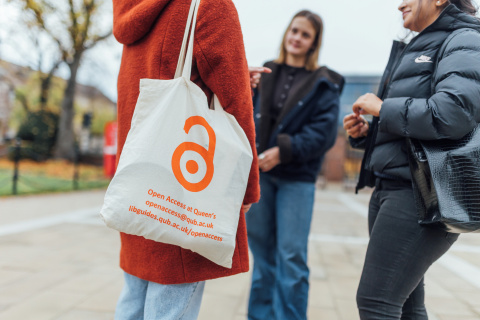 Student standing outside the Lanyon with Open Access tote bag
