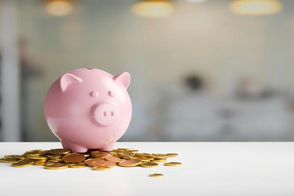 Piggy bank on top of coins