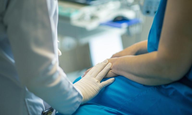 Doctor holding patients hand