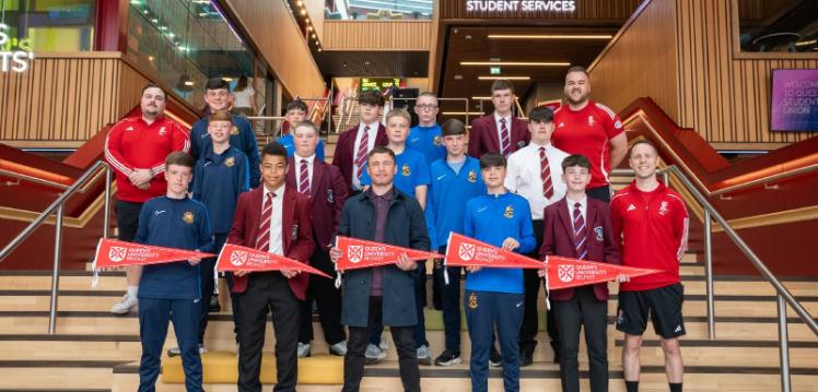 Students from Queen's Junior Sports Academy celebration event. Pictured on stairs of One Elmwood with Carl Frampton