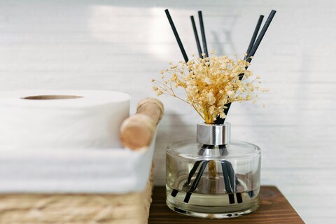 Reed diffuser beside toilet roll