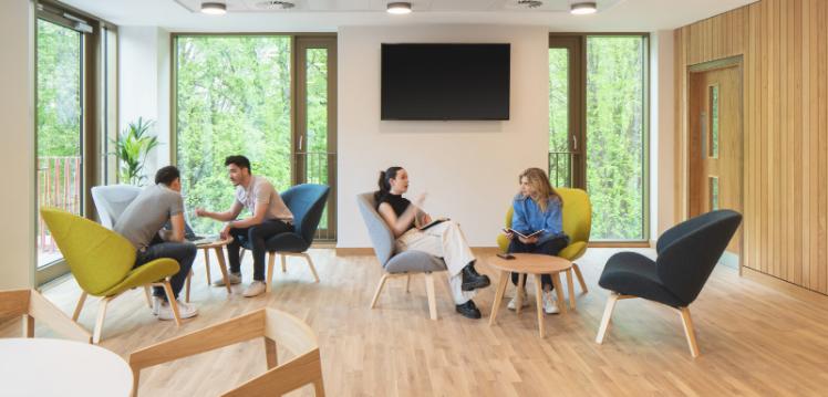 Four students in seating area in Riddel Hall