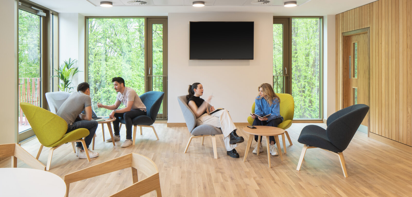 Four students in seating area in Riddel Hall