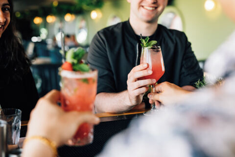 Two people drinking cocktails