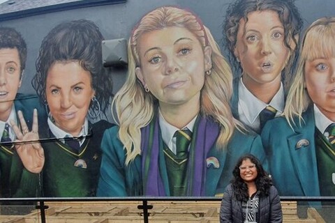 Student Sai Sree in front of the Derry Girls mural