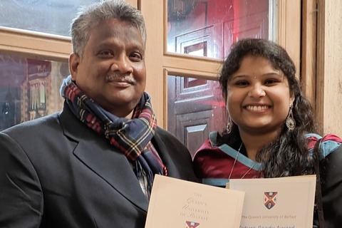 Student and her father on graduation day holding certificates