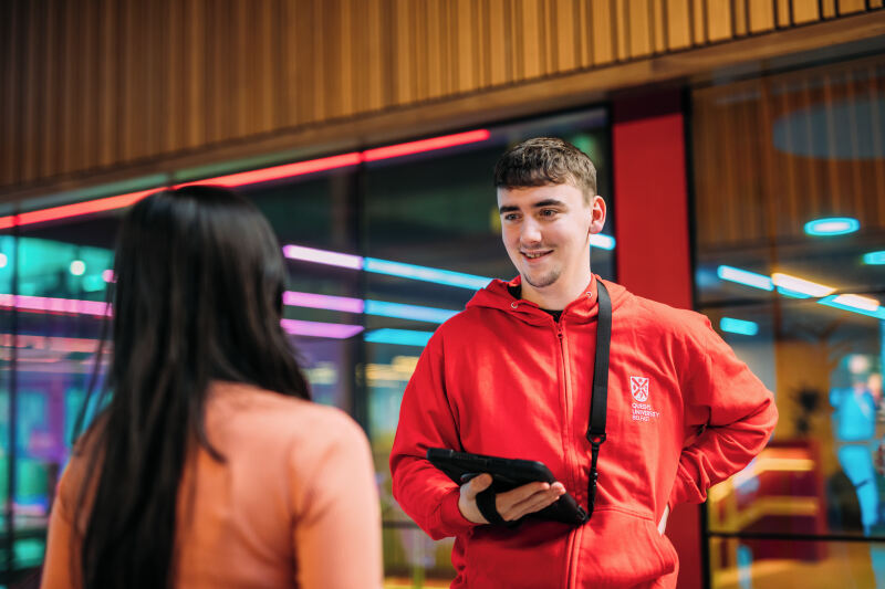 Student assistant talking to another student