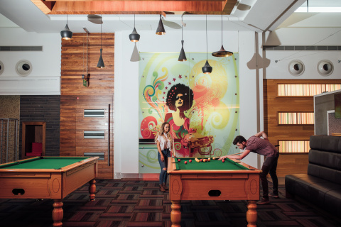 Two students playing pool in accommodation