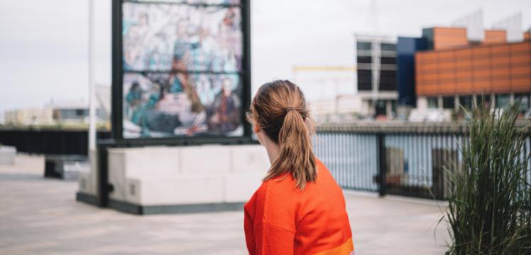 Student looking at Game of Thrones glass mural