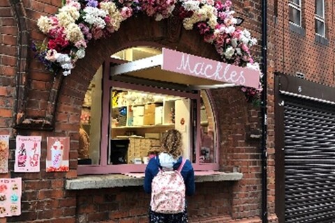 Student standing outside ice cream stand in Cathedral Quarter
