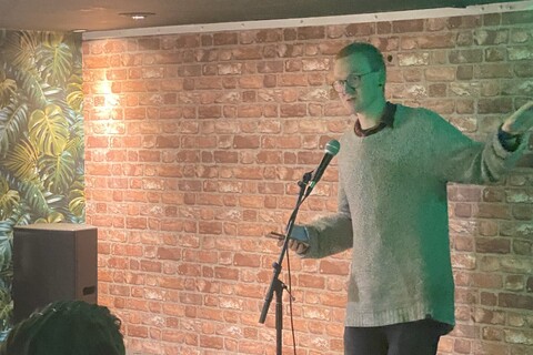 Student speaking at open mic event