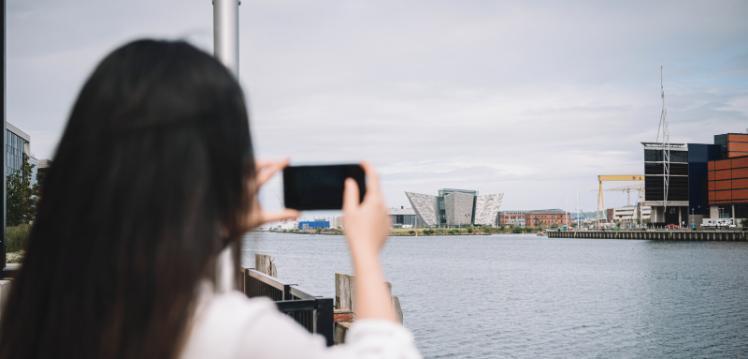 Student taking picture of Titanic Quarter