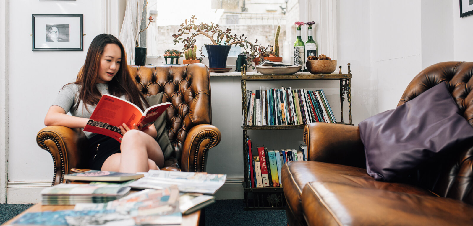 Student reading book in office