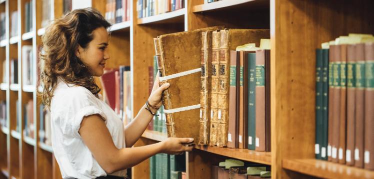 Student looking at books in the McClay