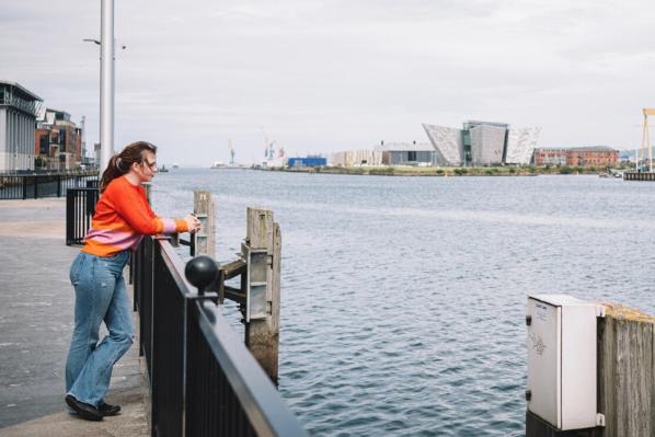 Student standing close to Titanic Quarter, overlooking the Lagan River