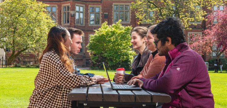 Students sitting on bench outside Junction cafe