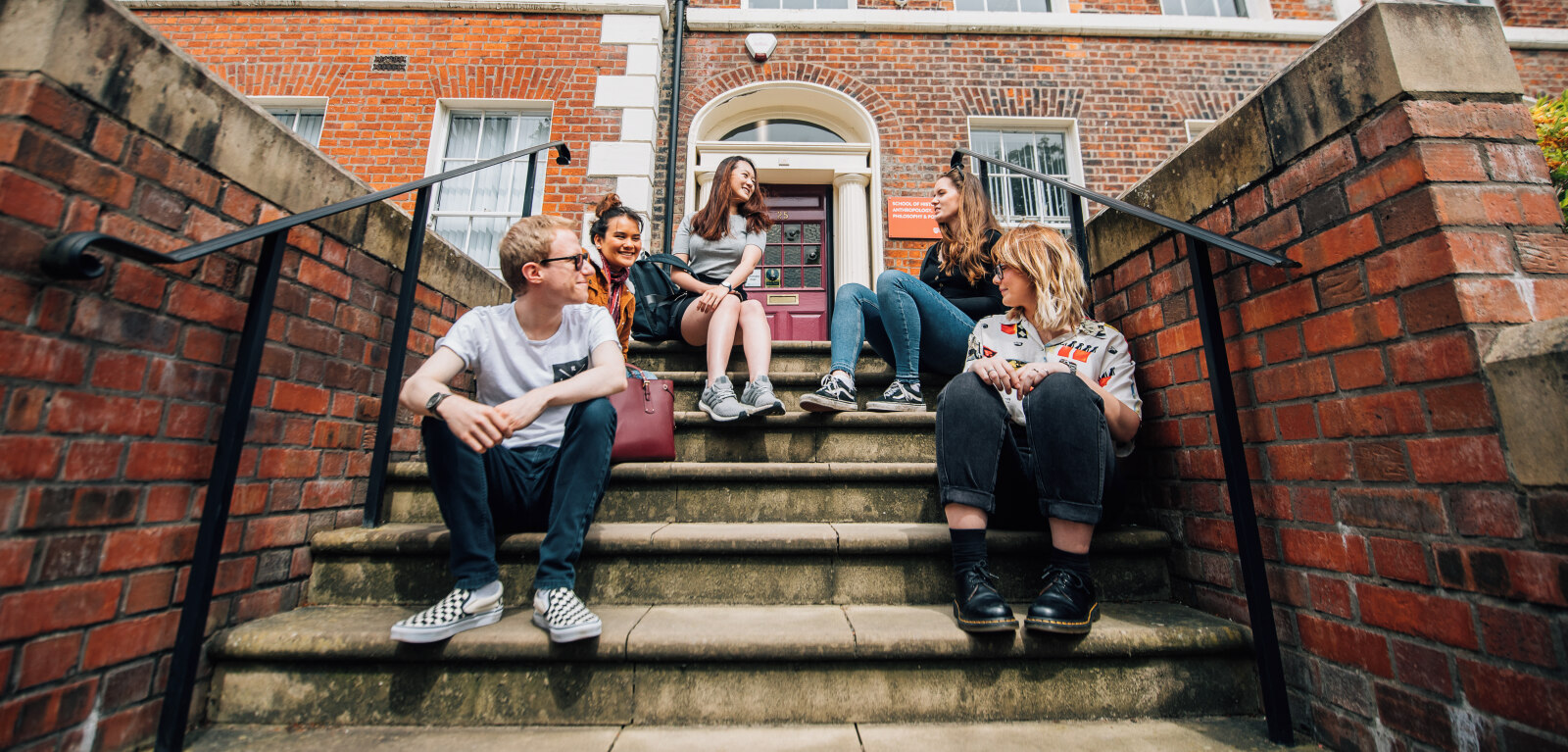 Group of students on steps on Queen's campus