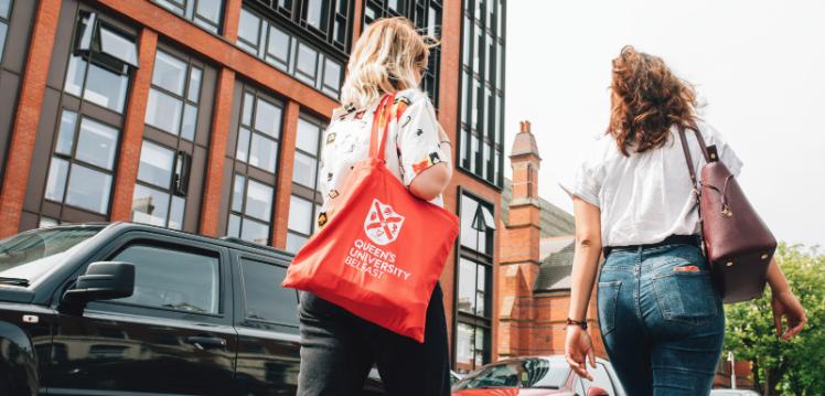 Two students walking past the School of Law