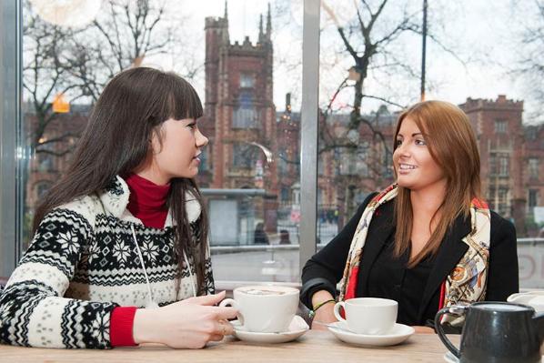 Students chatting over coffee in Queen's Students' Union