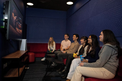 Group of students watching film in accommodation