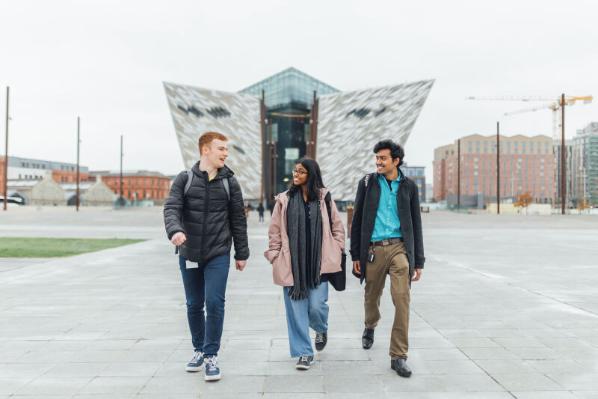 Three students walk down slipways with Titanic Museum in background