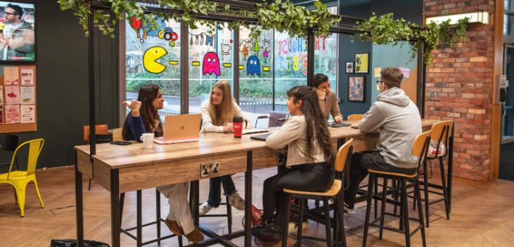 Group of students sitting at table in the Treehouse
