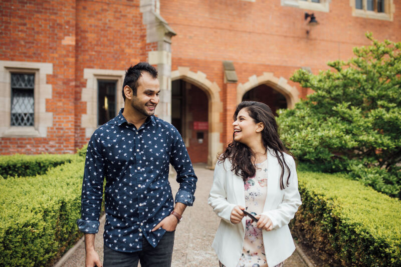 Two students walking through the Quad in the Lanyon