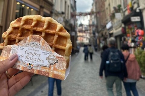 Student holding waffle in Brussels