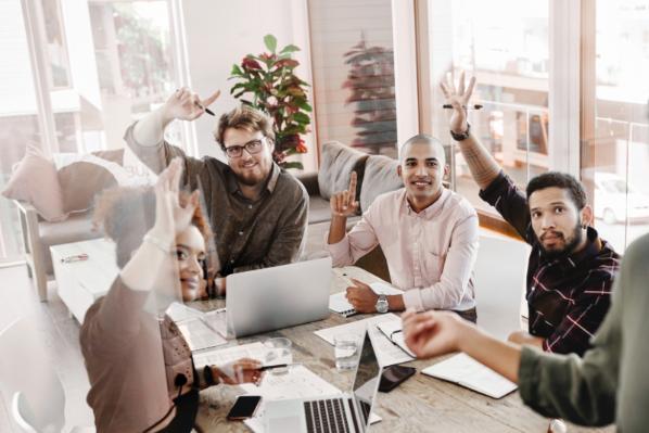 Individuals with raised hands to volunteer