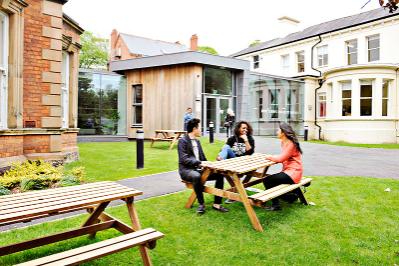 Students seated outside the INTO centre