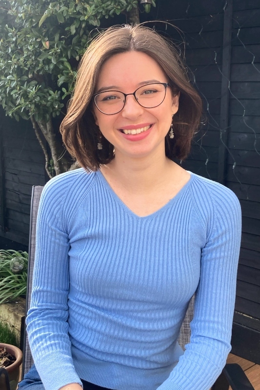 Head and shoulders of Ciara Gorman smiling, wearing a light blue v-neck top