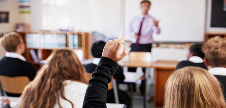 male teacher and pupils in classroom