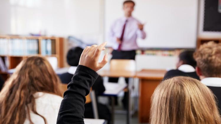 male teacher and pupils in classroom