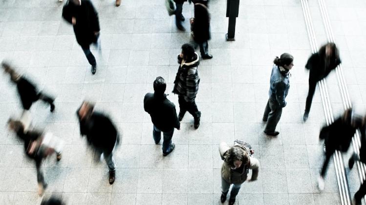 aerial view of blurred people on grey paved street