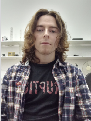 A headshot of a male student in a lab