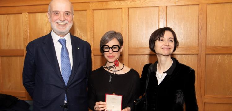 tall smiling man on left, small woman with short hair and glasses in centre and dark-haired smiling woman on right