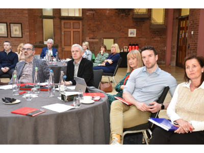 Passion HF Consortium delegates sitting around a circular table listening to the presenter