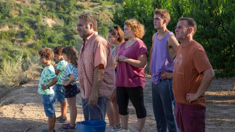 family standing looking into the hills