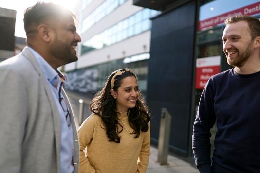 students chatting outside medical buildings