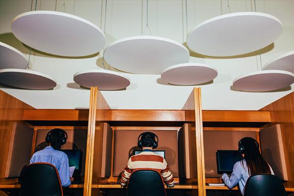 three students using computer facilities in the Queen's Language Centre