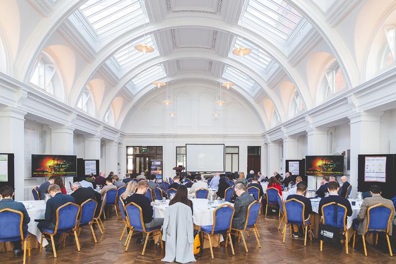 An image of a conference space with attendees