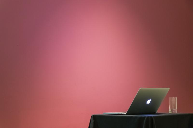 An image of a laptop on a table just before a presentation