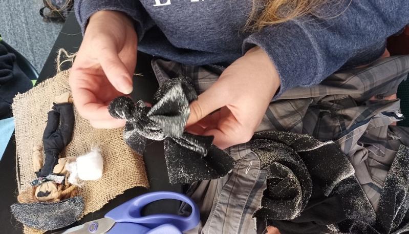 student's hands working with a variety of textiles