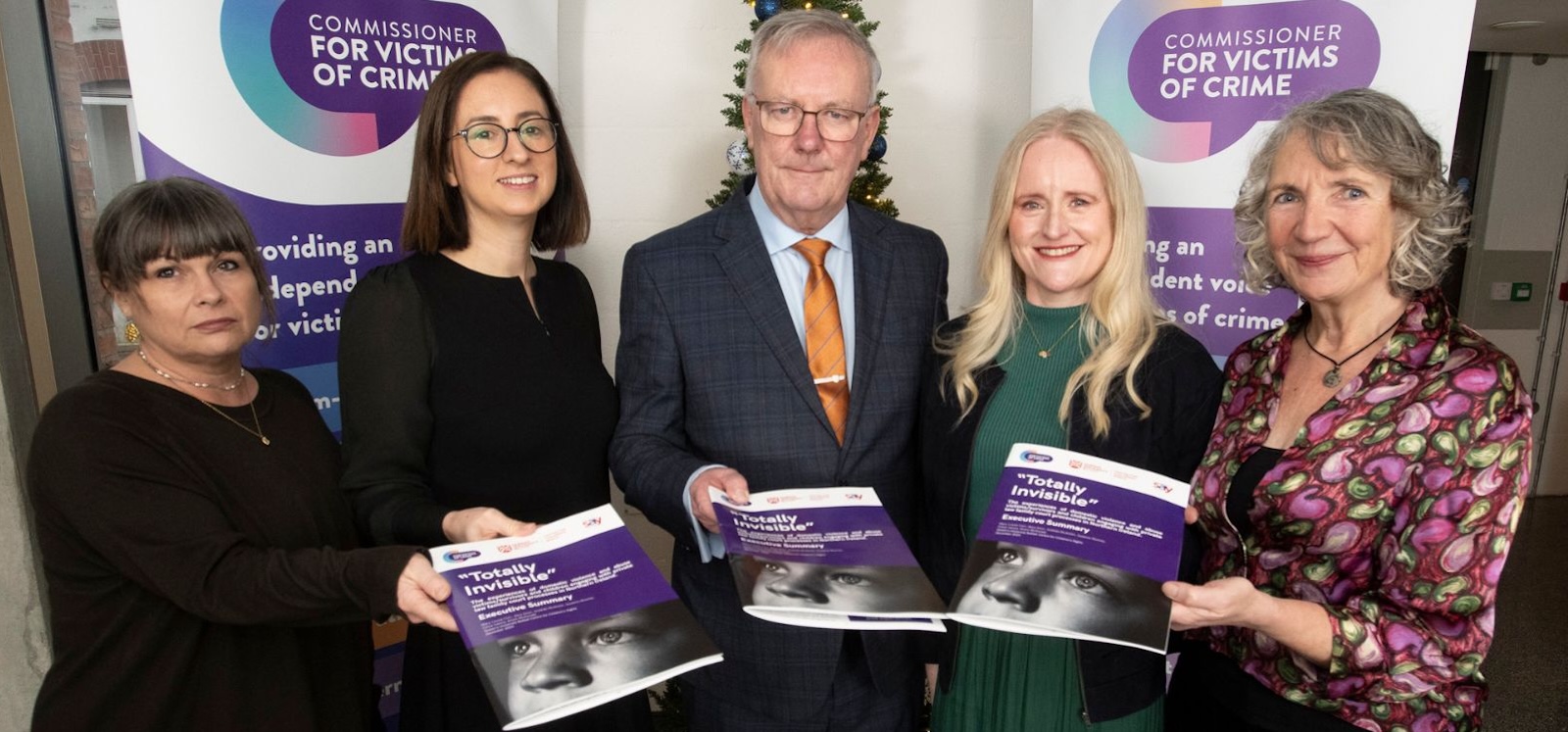 a group of people holding a publication