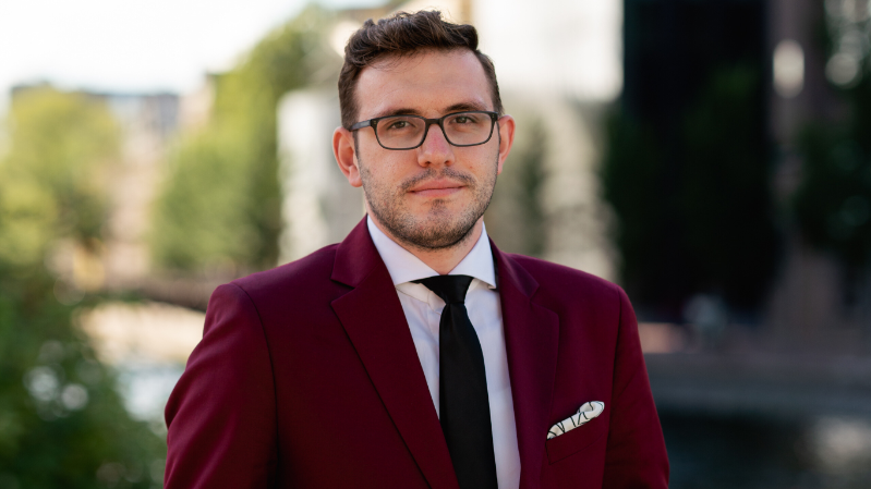 young man with spectacles wearing a fetching mauve blazer