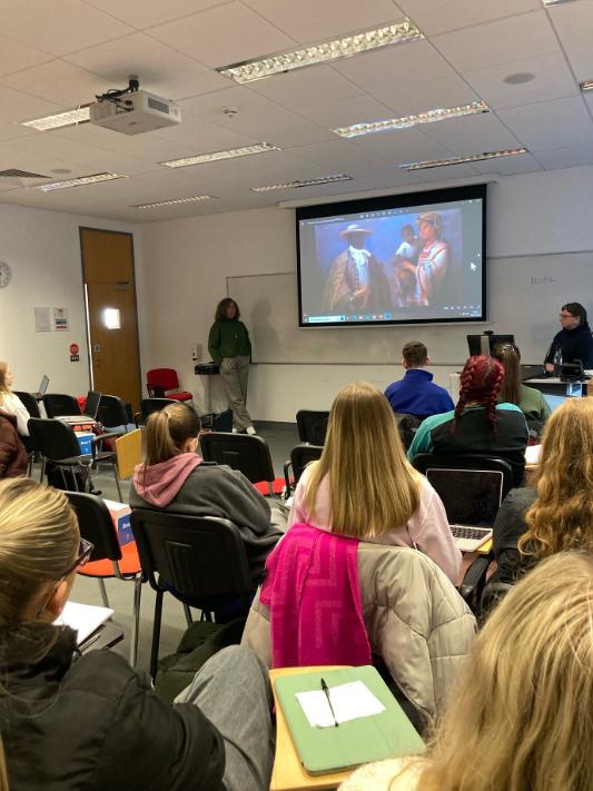 Lecture room filled with students watching a presentation