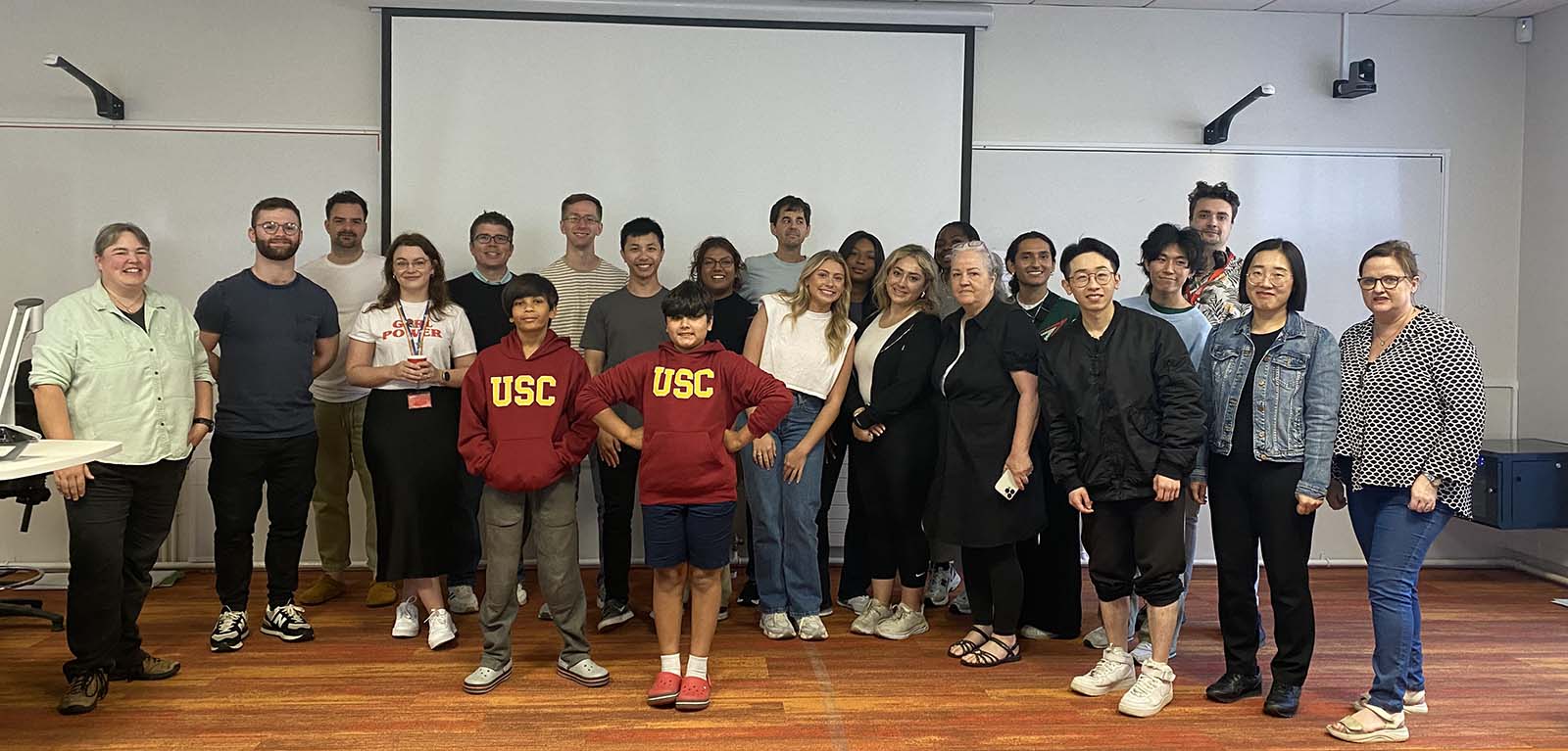 a group of smiling students in a classroom